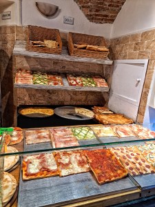 I am Sofia Lena Perissinotto, I am a blogger, content creator. In this article I write about Celle Ligure (Liguria, Italy). This photo depicts a typic focacceria, selling Ligurian focaccia and other delights of the place.