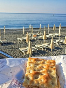 I am Sofia Lena Perissinotto, I am a blogger, content creator. In this article I write about Celle Ligure (Liguria, Italy). This photo depicts traditional Ligurian focaccia, truly a delight of this region!