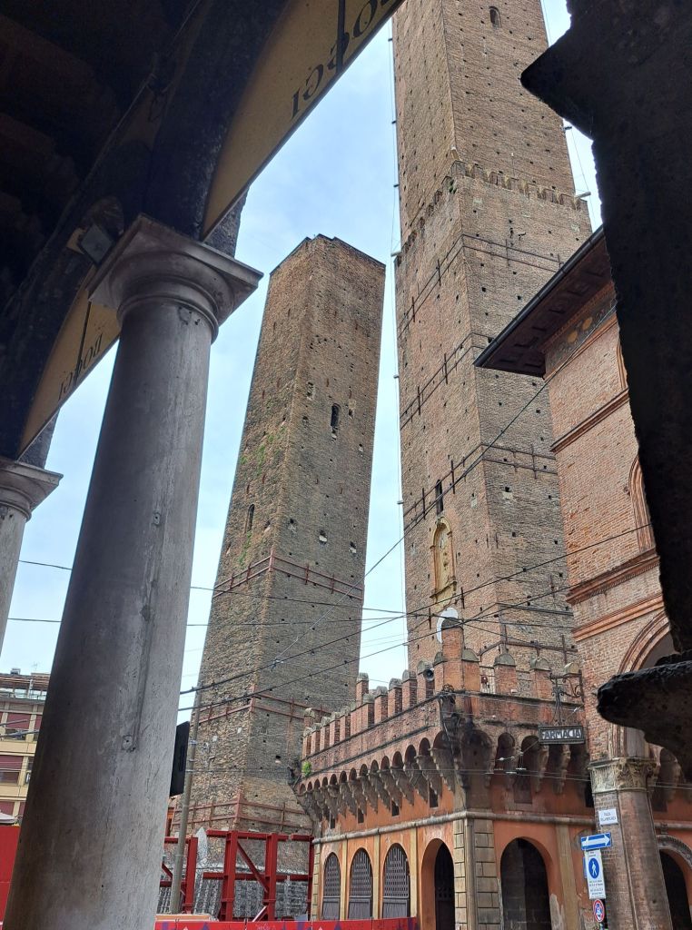 I'm Sofia Lena Perissinotto. I am a travel blogger. In this blog post I talk about Bologna, a stunning, historical city located in the Italian region Emilia-Romagna. In this photo you can see The Two Towers or Le Due Torri named Torre degli Asinelli and Torre Garisenda.