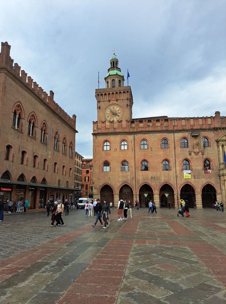 I'm Sofia Lena Perissinotto. I am a travel blogger. In this blog post I talk about Bologna, a stunning, historical city located in the Italian region Emilia-Romagna. The photo is taken in the stunning and most famous piazza of Bologna: Piazza Maggiore.