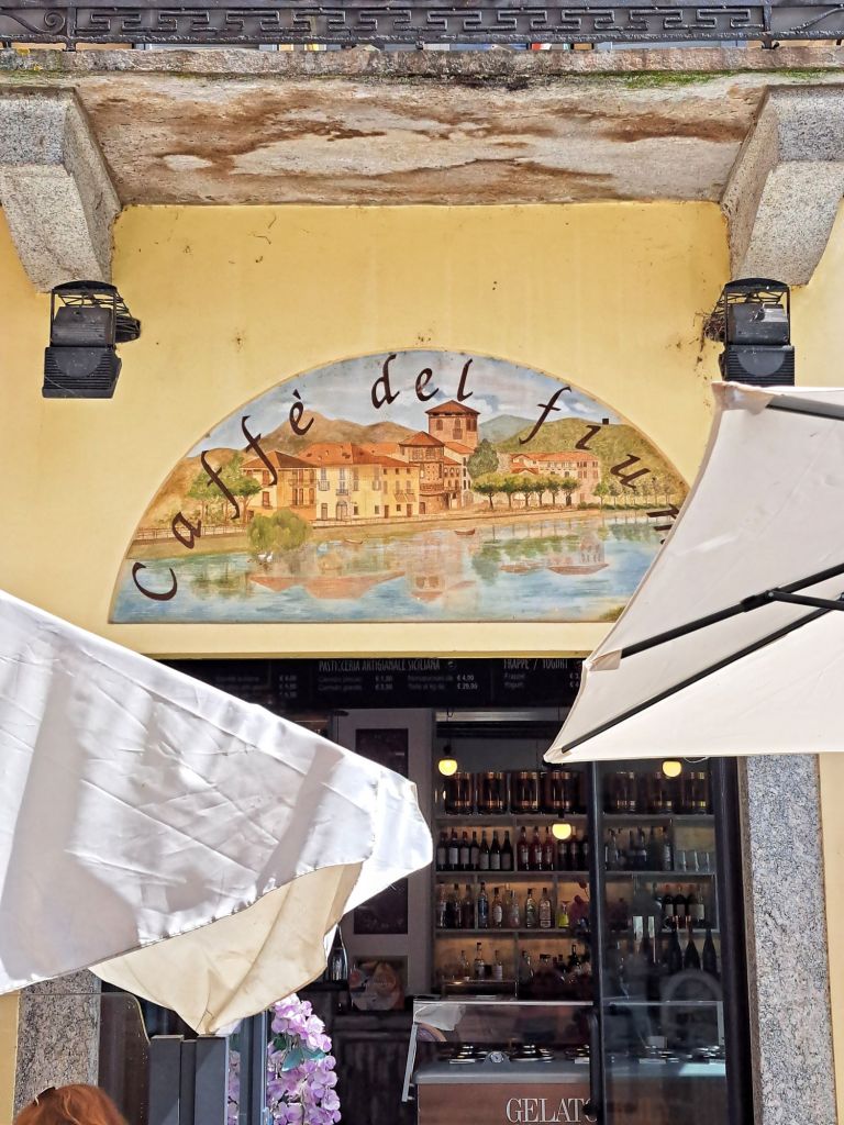 I am Sofia Lena Perissinotto, I am a travel blogger. In this blog post I write about the charming, picturesque town of Brivio in the province of Lecco, Lombardy region, Italy. I also write about some of my favourite cafes, the famous old bridge and the Northern Adda Park. This photo shows Caffè del Fiume.