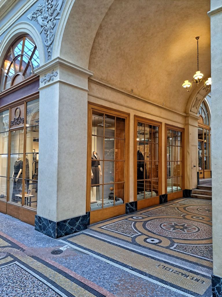 Hi, I'm Sofia Lena Perissinotto, I am a travel blogger. In this article I write about Paris, some iconic landmarks, why the city is special to me and also some café recommendations! This photo is taken at the stunning Galerie Vivienne.