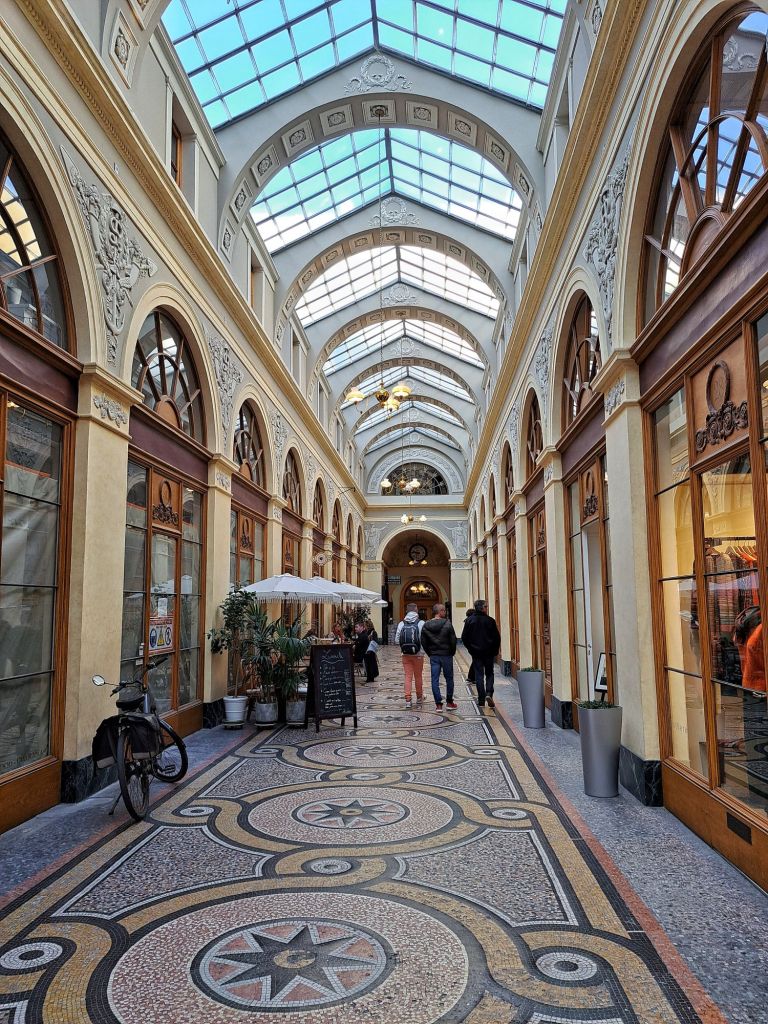 Hi, I'm Sofia Lena Perissinotto, I am a travel blogger. In this article I write about Paris, some iconic landmarks, why the city is special to me and also some café recommendations! This photo is taken at the stunning Galerie Vivienne.