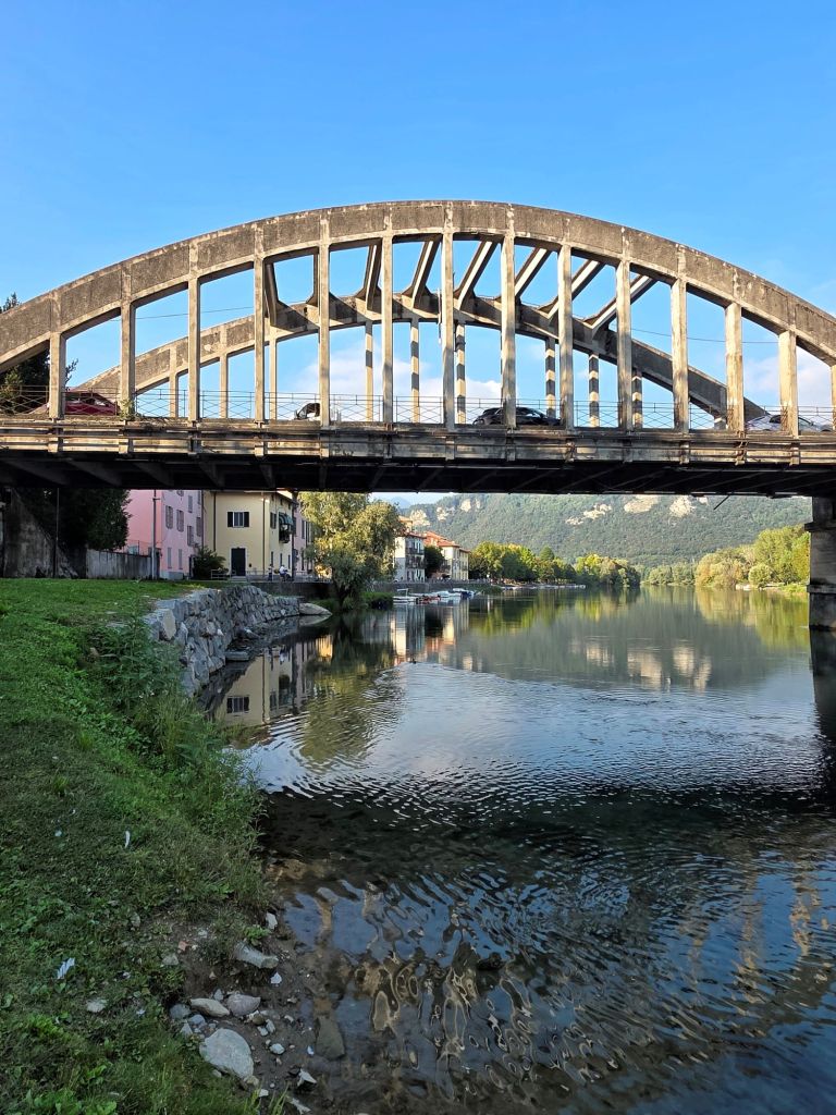 I am Sofia Lena Perissinotto, I am a travel blogger. In this blog post I write about the charming, picturesque town of Brivio in the province of Lecco, Lombardy region, Italy. I also write about some of my favourite cafes, the famous old bridge and the Northern Adda Park. This photo mainly shows a picturesque Brivio photo with the Old Bridge.