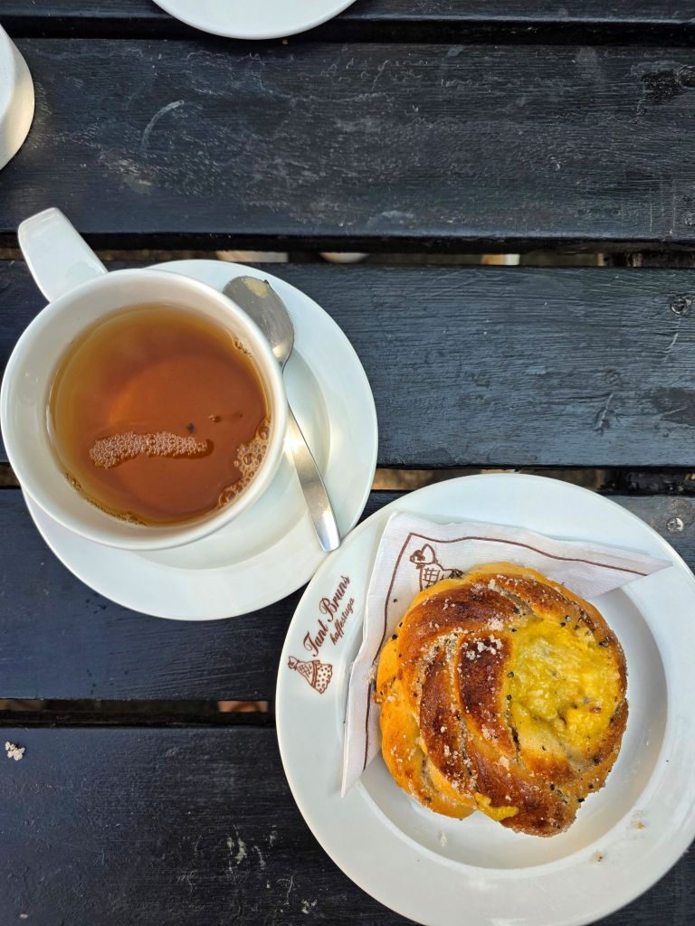 In this travel article I write about Sigtuna, Sweden's oldest town. The photo shows a cardamom bun with green tea at Tant Bruns Kaffestuga, a historic 17th-century café.